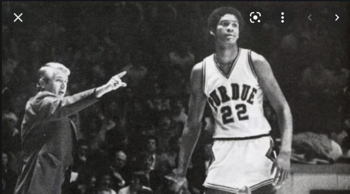 Purdue coach Lee Rose (left) gives instructions to center Joe Barry Carroll during the 1980 season.